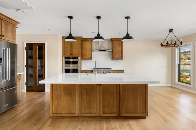 a living room with kitchen island furniture and wooden floor