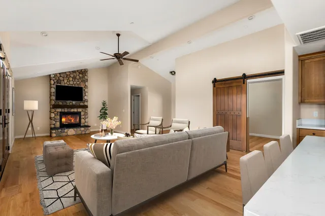 a view of empty room with wooden floor and a ceiling fan