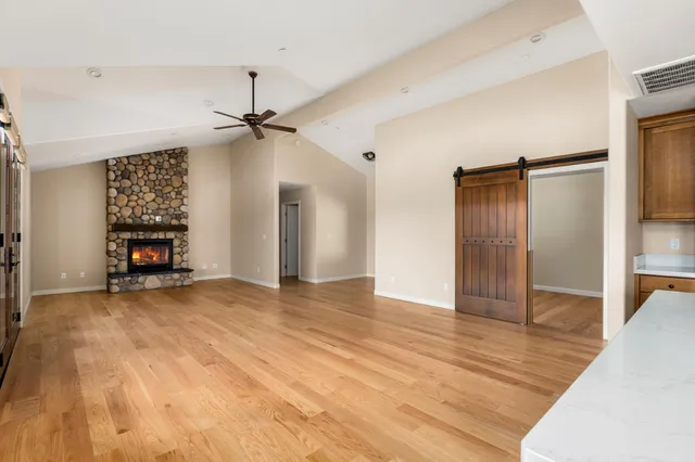 a view of an empty room with wooden floor