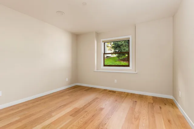 a bathroom with a granite countertop sink mirror vanity and toilet
