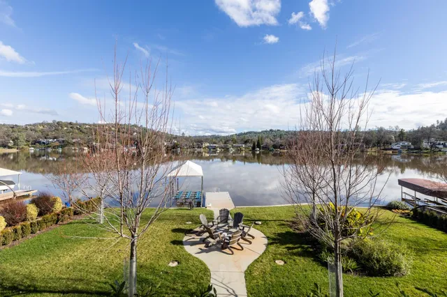 a view of house with swimming pool and outdoor seating