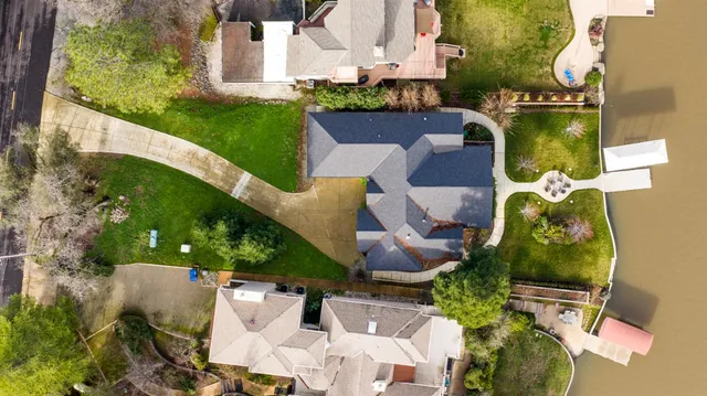a front view of a house with a garden and yard