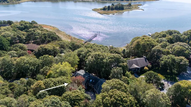 an aerial view of a house with a lake view