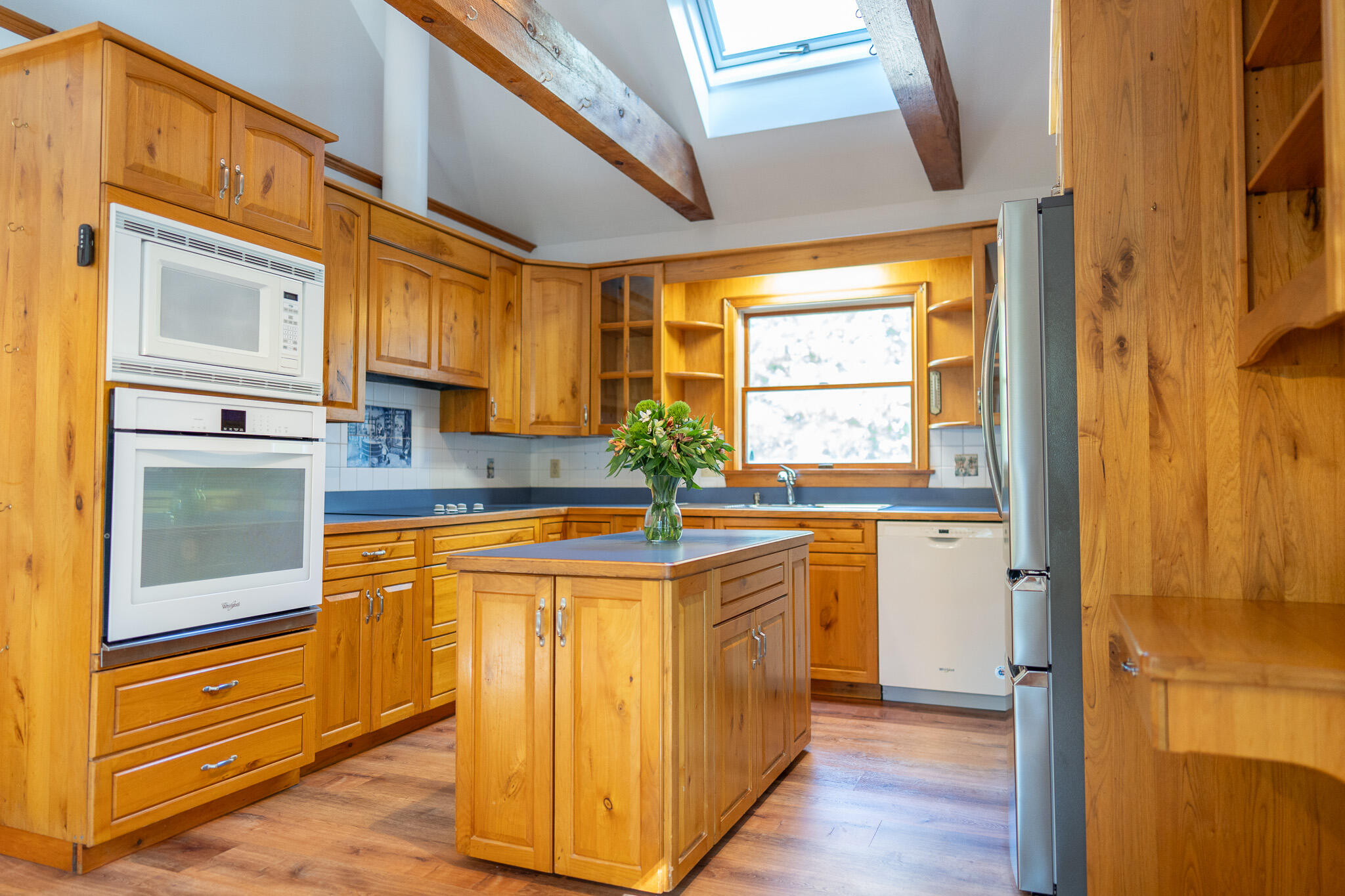 20 Kittiwake Lane Eastham, MA 02642 - Photo 11 of 75 a kitchen with stainless steel appliances granite countertop a refrigerator a sink dishwasher and wooden cabinets with wooden floor