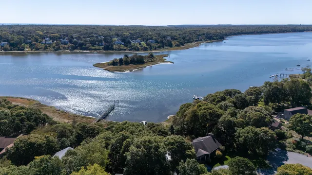 an aerial view of a house with a yard and lake view