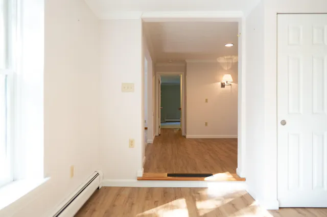a bathroom with a sink a toilet and a window