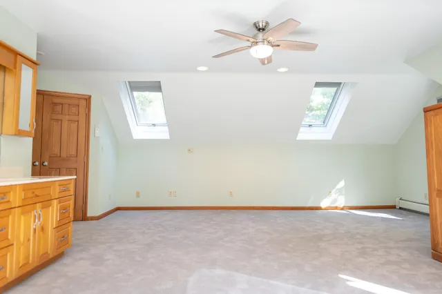 a view of a house with a yard and large tree