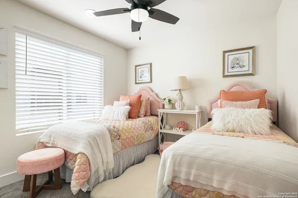 a bedroom with two beds and a lamp