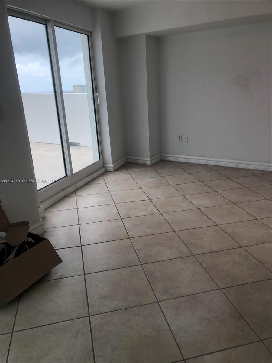 7600 Collins Avenue, Unit 1008 Miami Beach, FL 33141 - Photo 4 of 9 a view of an empty room with a window