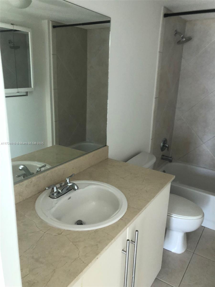 7600 Collins Avenue, Unit 1008 Miami Beach, FL 33141 - Photo 8 of 9 a bathroom with a sink and a toilet