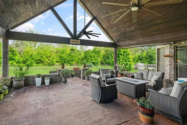 a living room with patio furniture and a yard