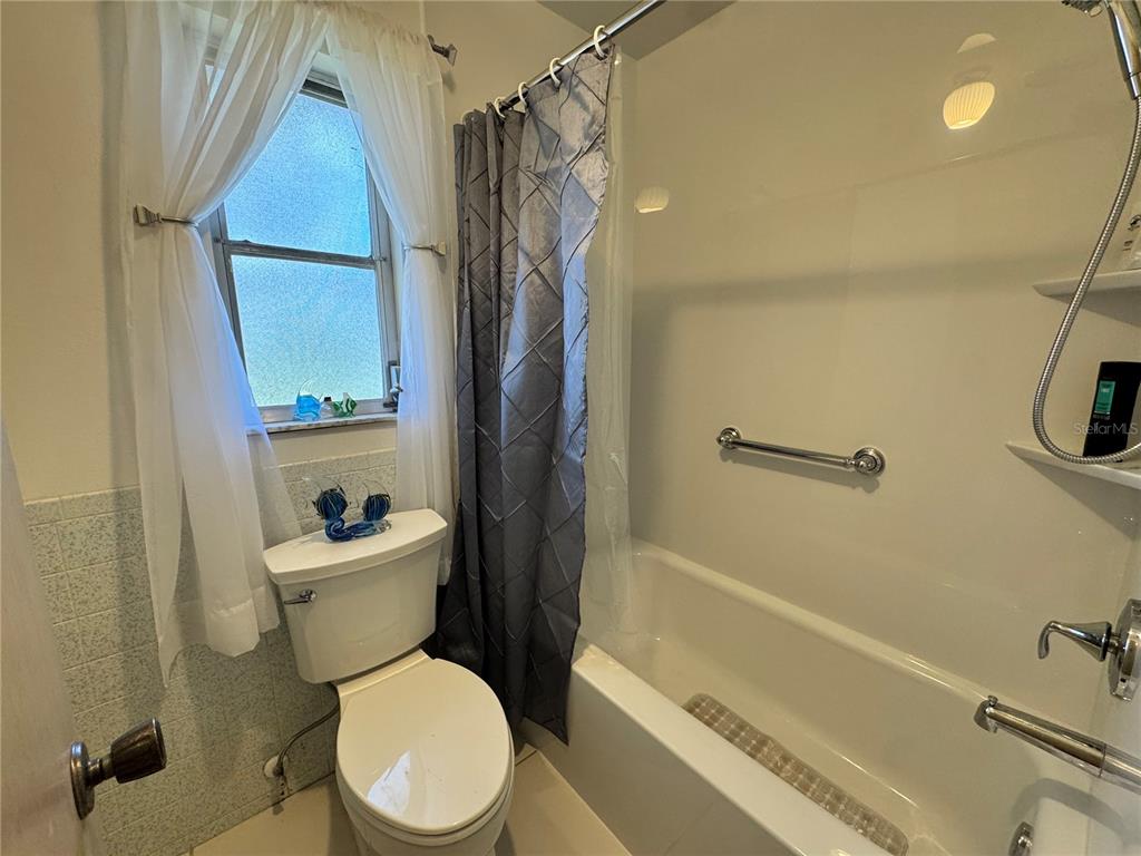 1048 Porpoise Road Venice, FL 34293 - Photo 21 of 26 a white toilet sitting next to a bath tub