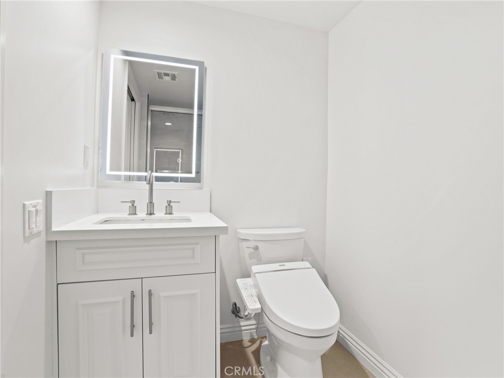 1598 Long Beach, Unit 214 Long Beach, CA 90813 - Photo 16 of 30 a bathroom with a sink toilet and a mirror