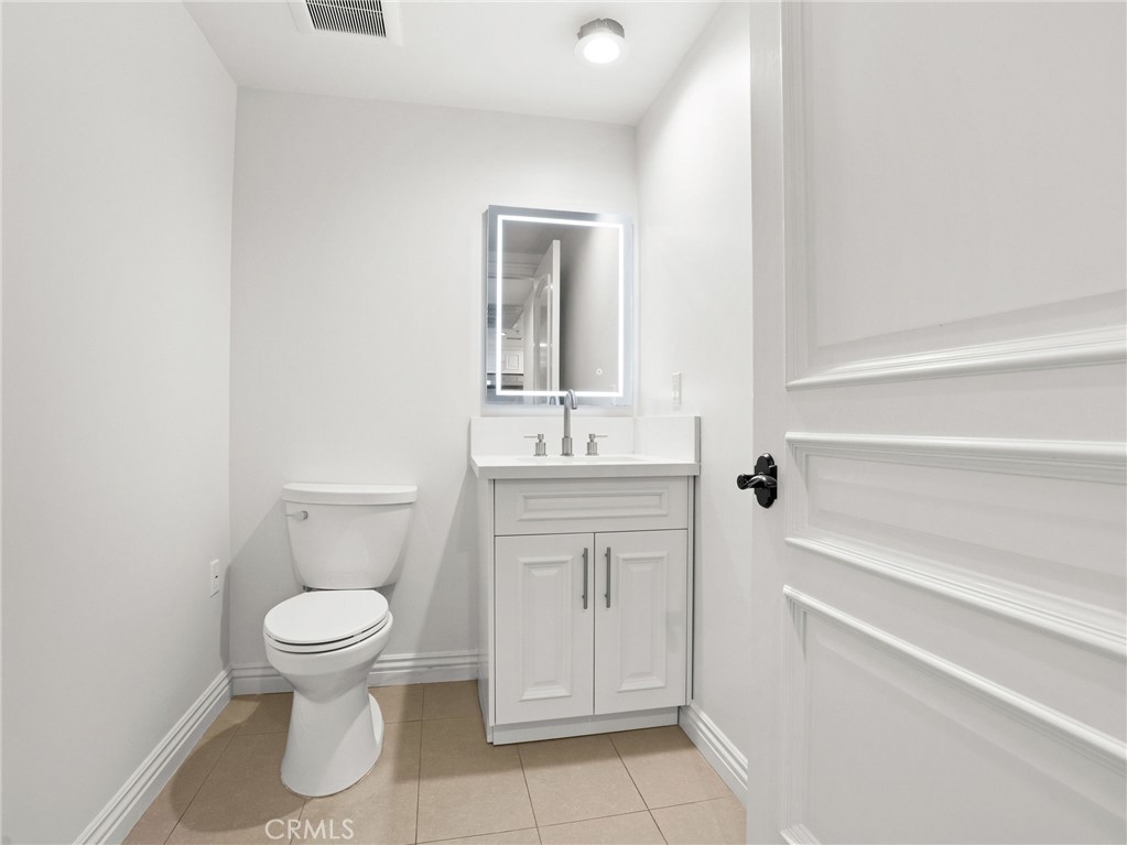 1598 Long Beach, Unit 214 Long Beach, CA 90813 - Photo 23 of 30 a bathroom with a toilet sink and a mirror