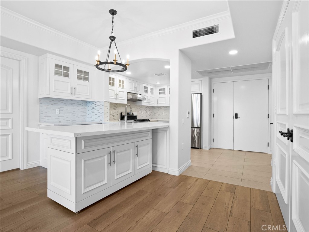1598 Long Beach, Unit 214 Long Beach, CA 90813 - Photo 3 of 30 a kitchen with white cabinets and stainless steel appliances