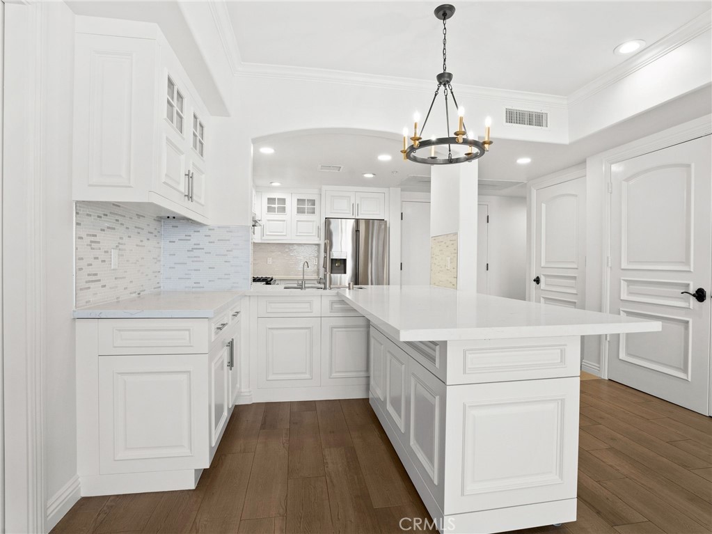 1598 Long Beach, Unit 214 Long Beach, CA 90813 - Photo 4 of 30 a kitchen with white cabinets appliances and wooden floor