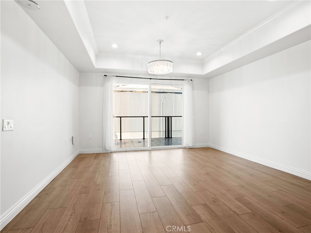 1598 Long Beach, Unit 214 Long Beach, CA 90813 - Photo 6 of 30 an empty room with wooden floor and windows