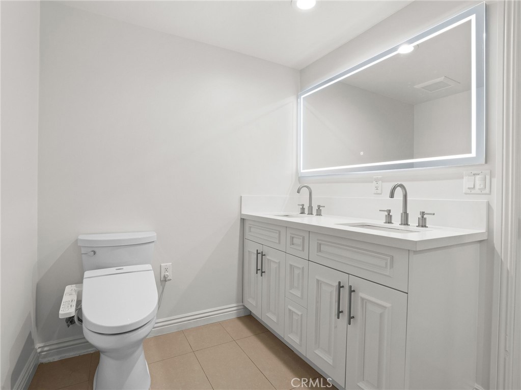 1598 Long Beach, Unit 214 Long Beach, CA 90813 - Photo 10 of 30 a bathroom with a toilet sink and mirror