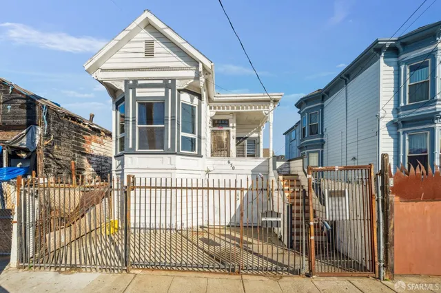 a view of a house with a iron gate