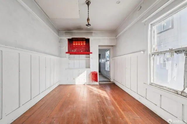 a very nice looking room with wooden floor and natural light