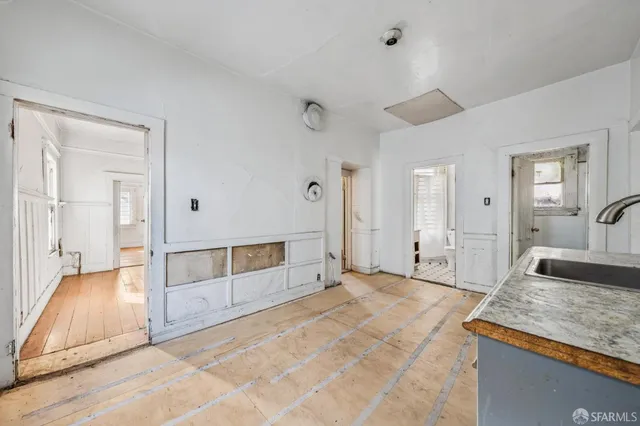 a spacious bedroom with a granite countertop sink and a mirror