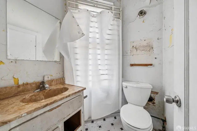 a bathroom with a granite countertop toilet sink and shower