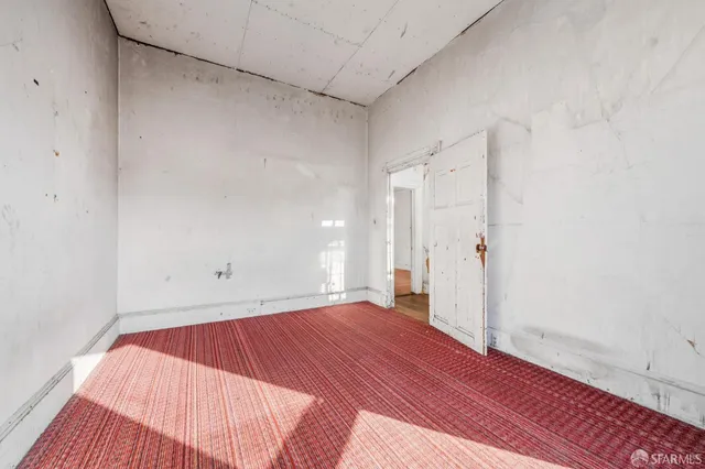 a view of a room with wooden floor and white walls