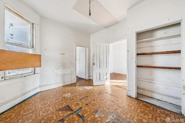 a view of room with wooden floor and cabinet