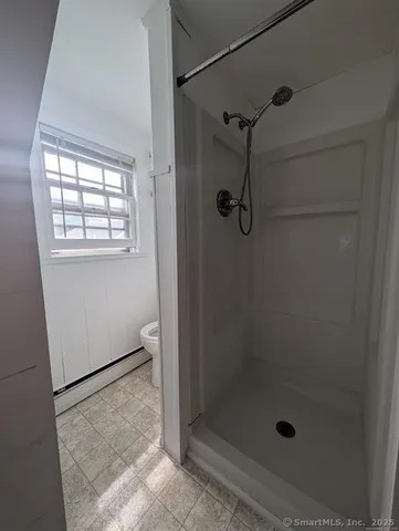 a bathroom with a glass shower door