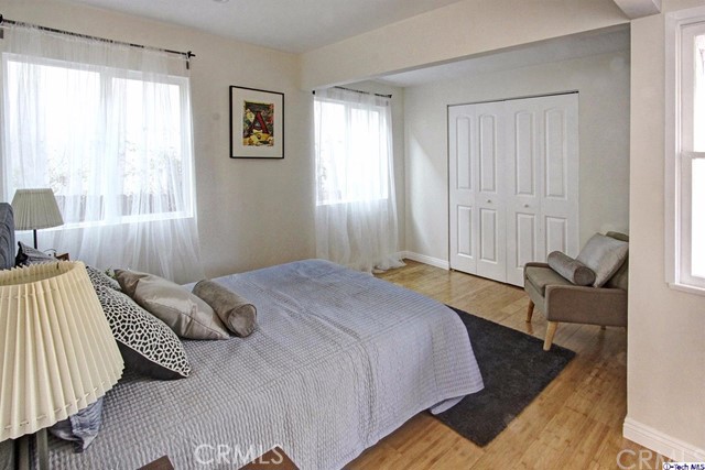 10563 Irma Avenue Tujunga, CA 91042 - Photo 11 of 25 a bed sitting in a bedroom next to a window