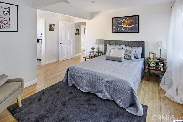 10563 Irma Avenue Tujunga, CA 91042 - Photo 12 of 25 a bedroom with bed and a couch