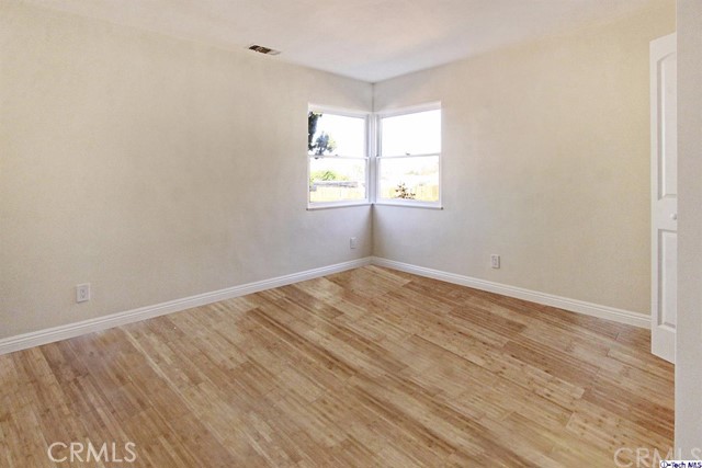 10563 Irma Avenue Tujunga, CA 91042 - Photo 16 of 25 wooden floor in an empty room with a window