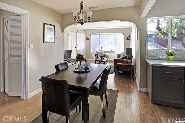 10563 Irma Avenue Tujunga, CA 91042 - Photo 7 of 25 a view of a dining room with furniture and wooden floor