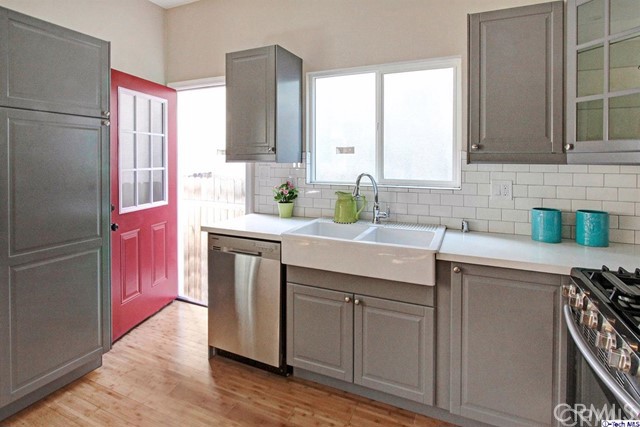 10563 Irma Avenue Tujunga, CA 91042 - Photo 9 of 25 a kitchen with a sink cabinets and stainless steel appliances