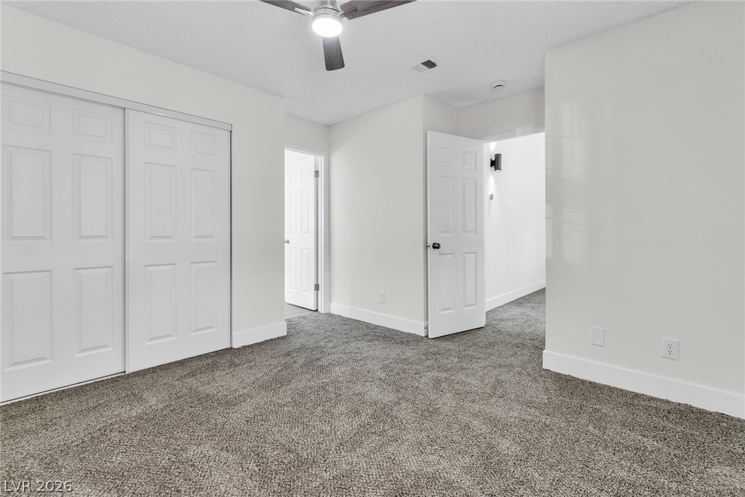 370 Rushing Creek Court Henderson, NV 89014 - Photo 26 of 32 Plush wall-to-wall carpeting and clean neutral walls anchor this versatile secondary bedroom space.
