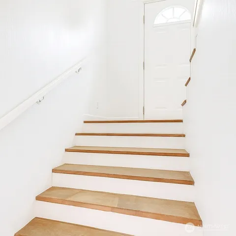 a view of granite countertop white cabinets and wooden floor