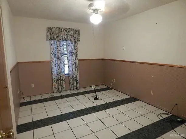 a room with a table and a chandelier
