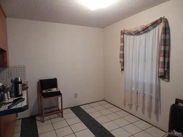 a view of a room with window and hardwood floor