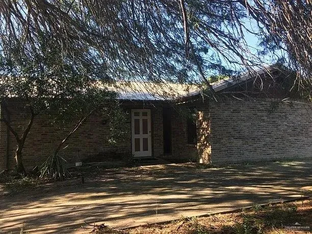 a view of street along with house and trees