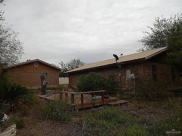 a backyard of a house with lots of green space and garden
