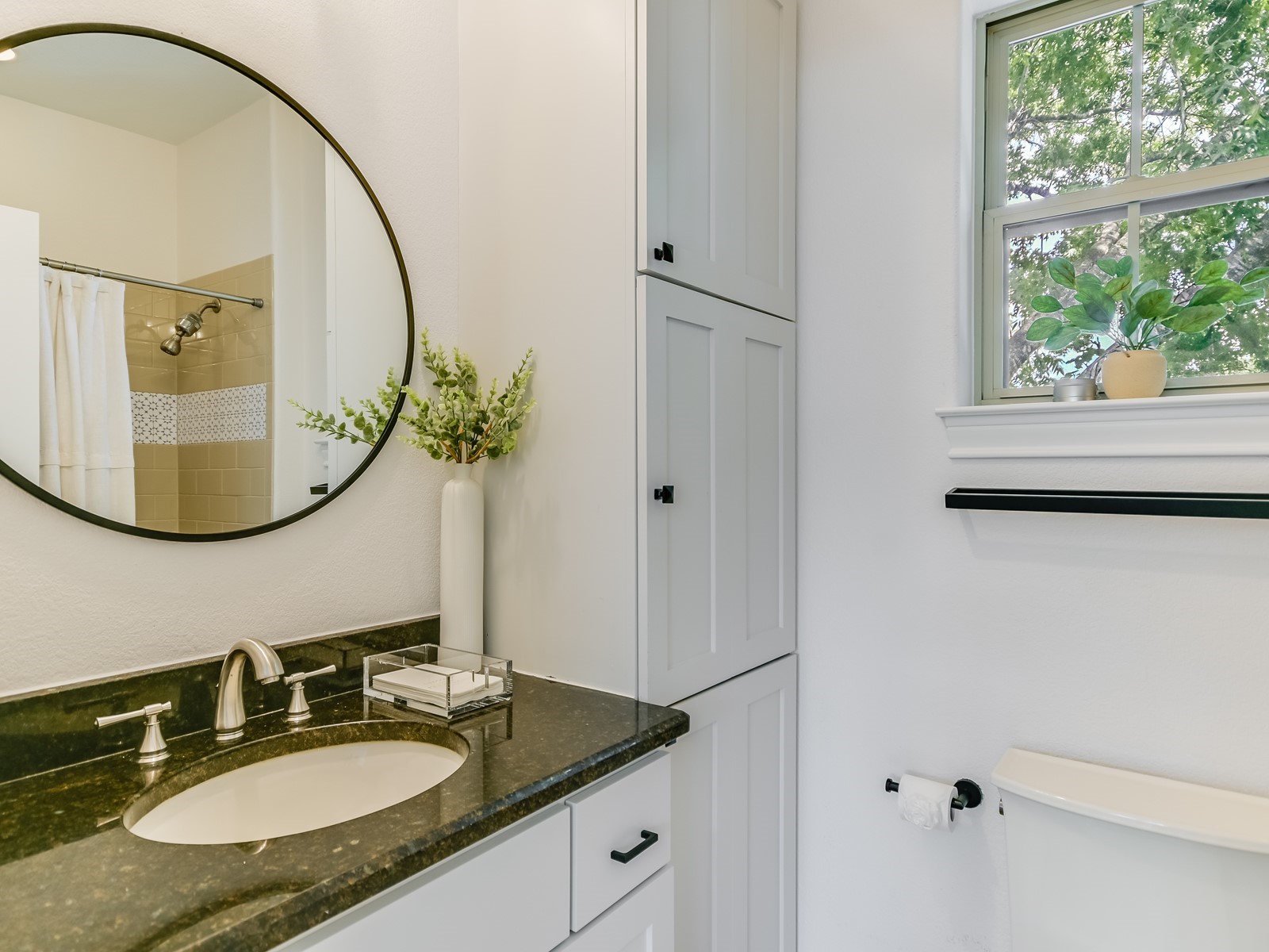 809 Kinney Avenue Austin, TX 78704 - Photo 17 of 21 a bathroom with a granite countertop sink and a mirror