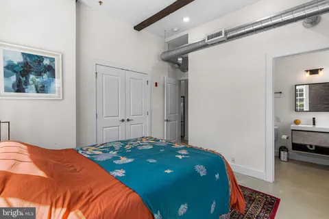 a bedroom with a bed and a table in it