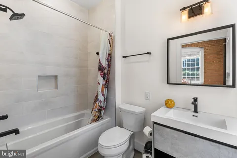a bathroom with a sink toilet a shower and a bathtub