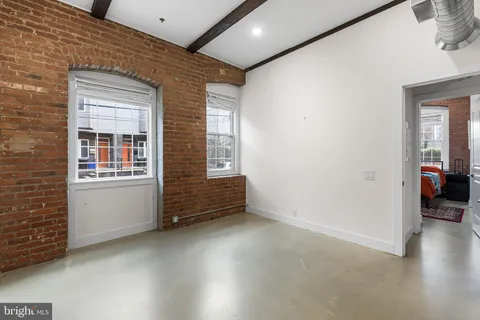 a view of room with window and wooden floor