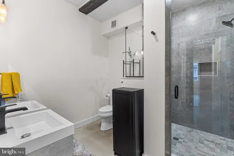 a bathroom with a sink toilet and shower
