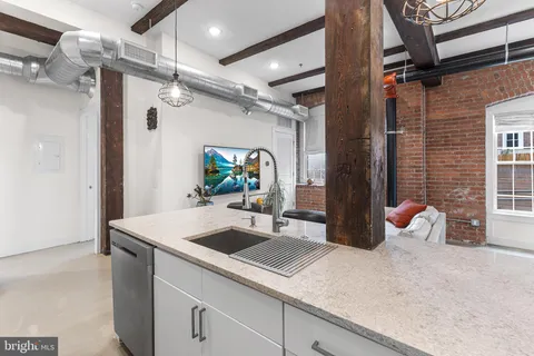 a kitchen with a sink and refrigerator