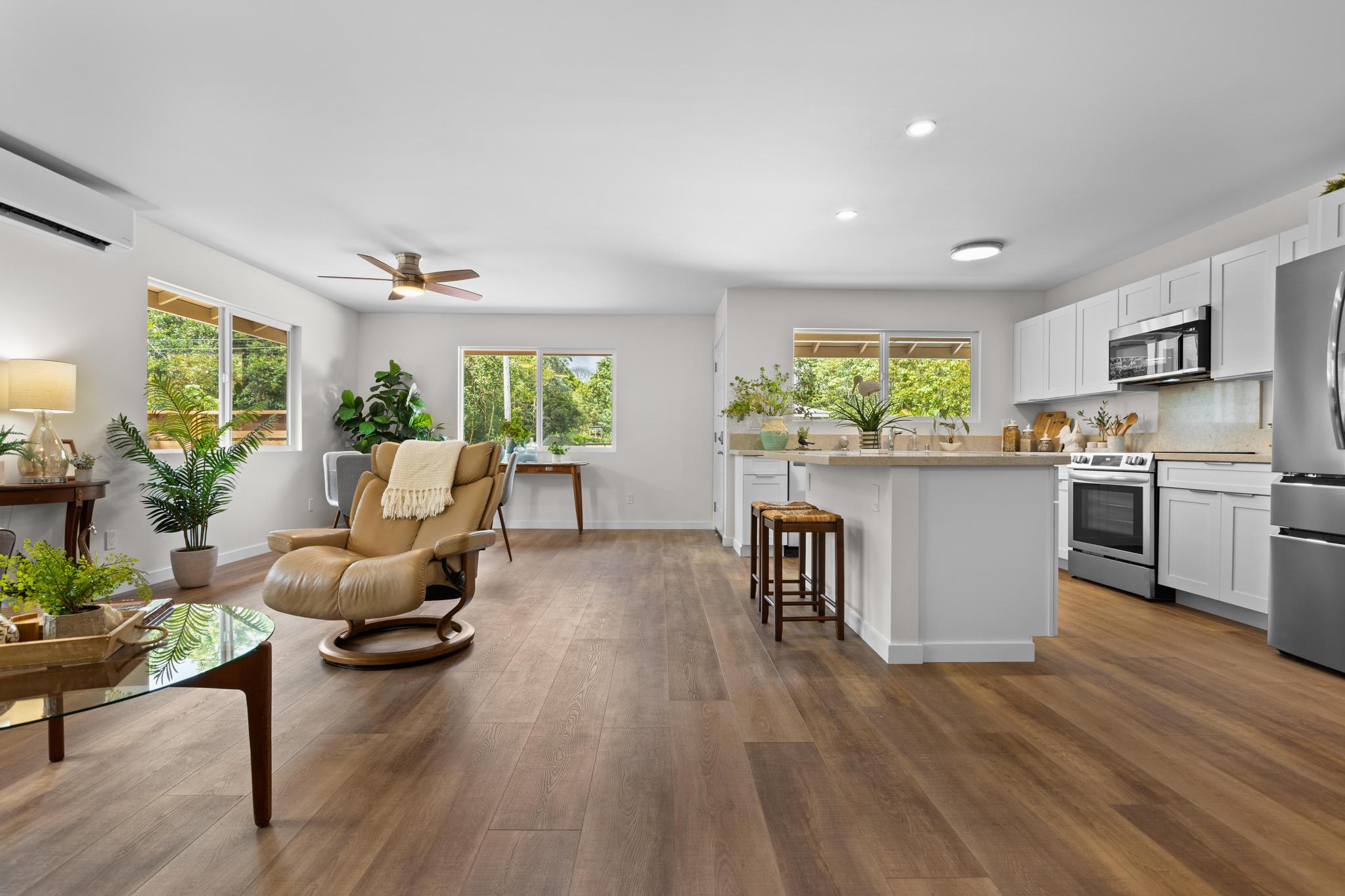 a living room with kitchen island furniture and a wooden floor