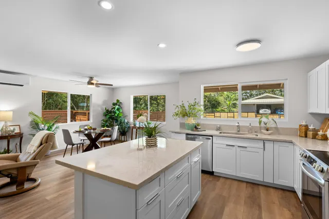 a kitchen with a sink stove and cabinets