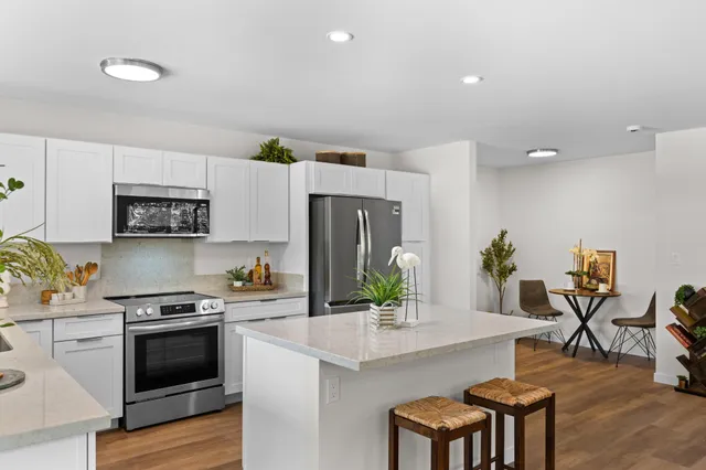 a kitchen with granite countertop a stove and a refrigerator
