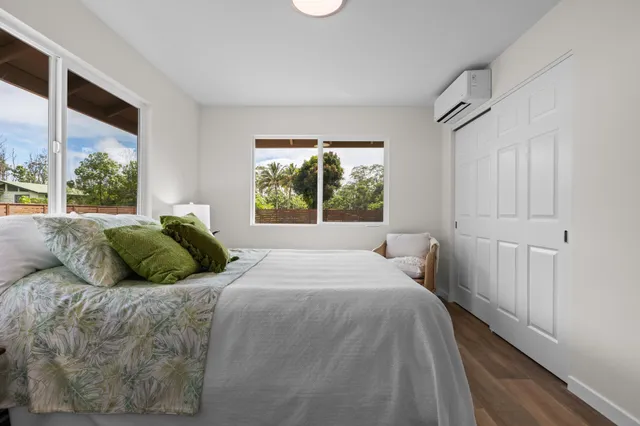 a bed sitting in a bedroom next to a window